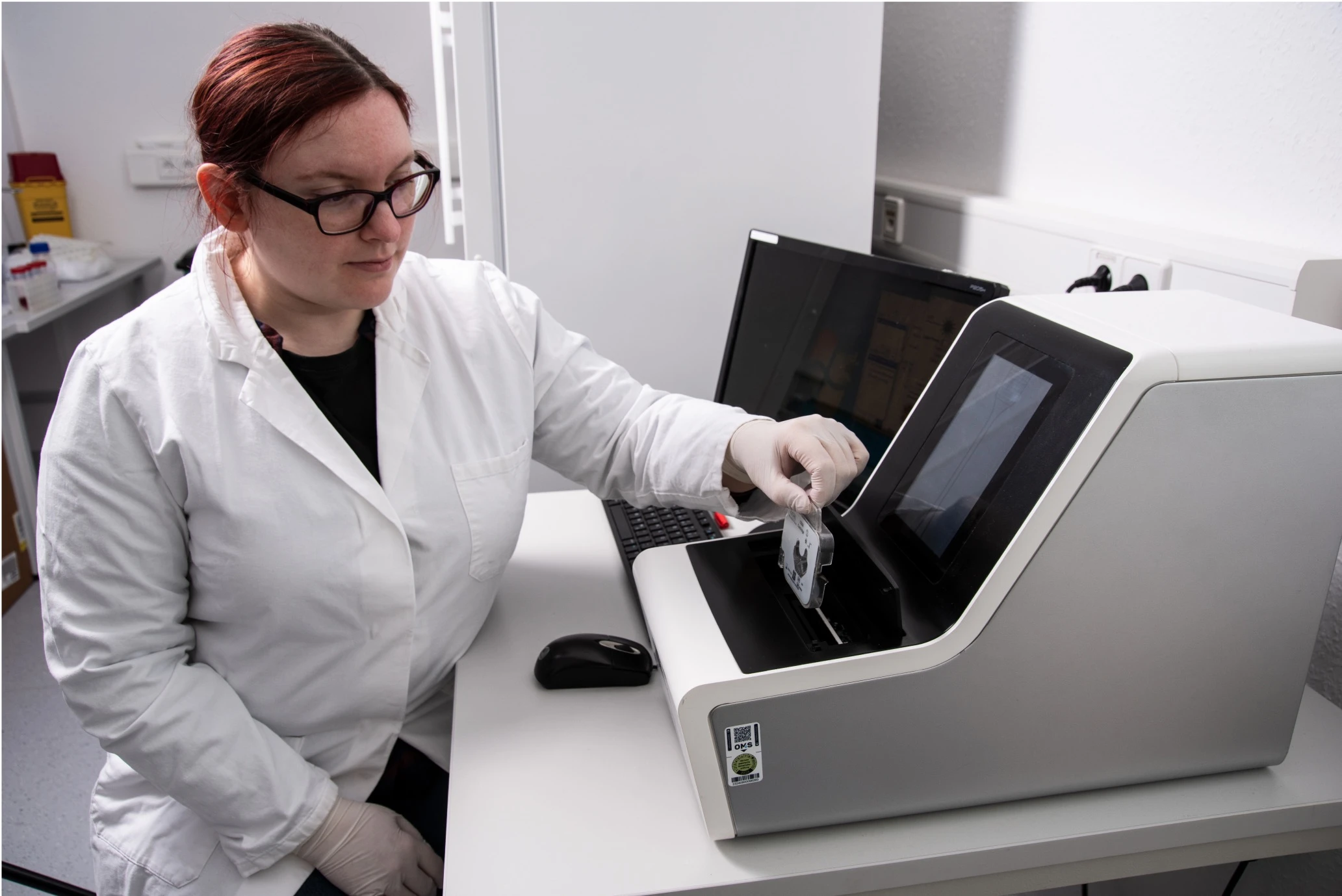 A person using a Laboratory Analytical Instrument